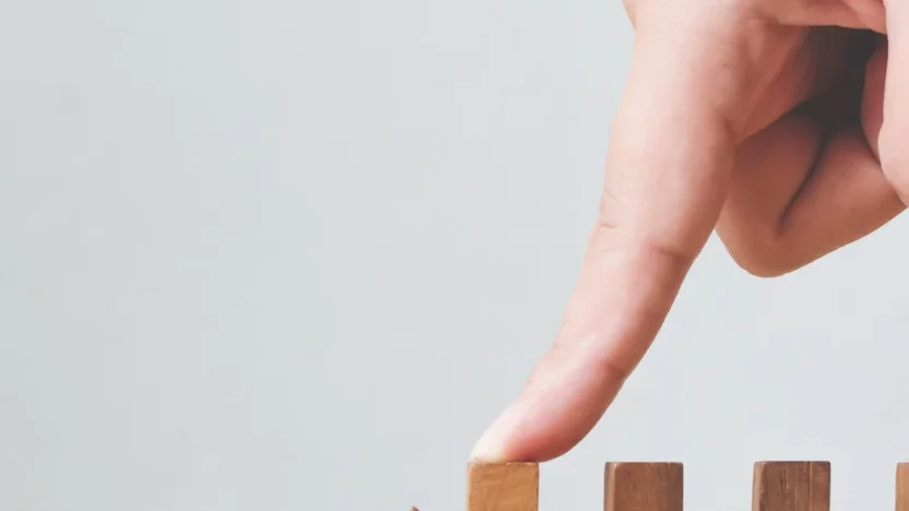 GenAI risks_ person pushing wood blocks