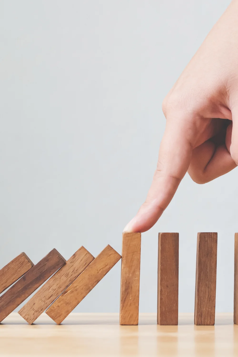 GenAI risks_ person pushing wood blocks