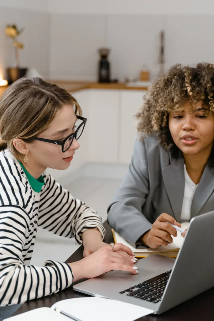 two women working on a laptop