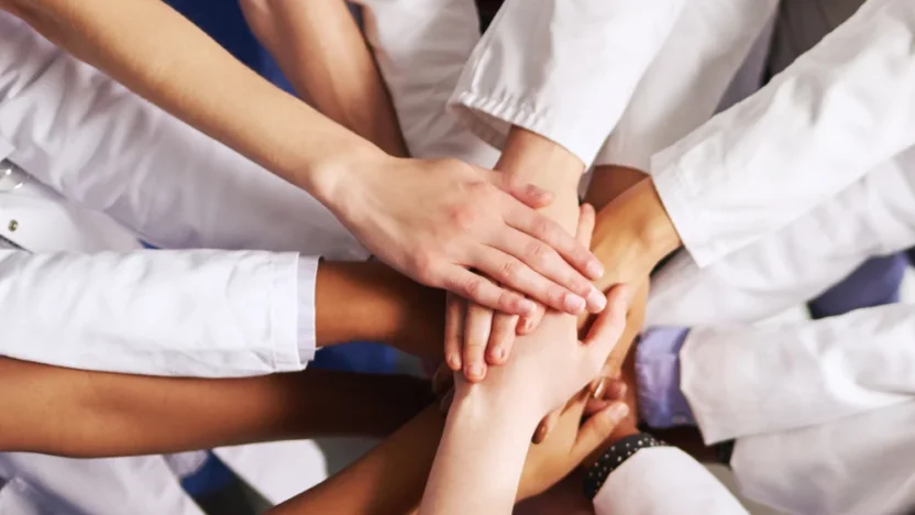 genai healthcare hands together